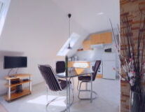 a living area with a desk and chair in a room