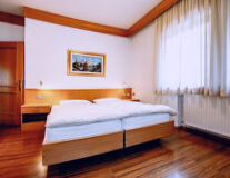 a bedroom with a wooden floor