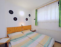 a bedroom with a bed and painted green
