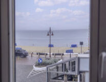 a view of a beach next to the window