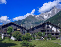 a large building with a mountain in the background