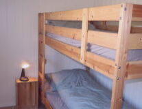 a bedroom with a bed and wooden furniture