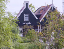 a house with trees in the background with House of the Seven Gables in the background