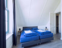 a blue bed in a room