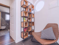 a living room filled with furniture and a book shelf