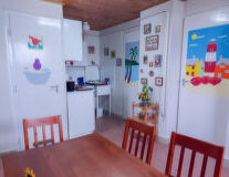 a kitchen with a refrigerator and table in a room
