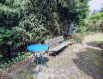 a blue bench in a garden
