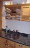 a kitchen with wooden cabinets and a sink