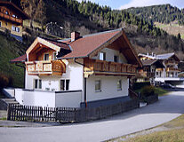 a house with a mountain in the background