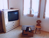 a television is sitting on a wooden floor