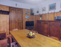 a kitchen with wooden cabinets and a hard wood floor