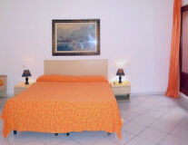 floor, orange, indoor, wall, couch, pillow, sofa bed, studio couch, curtain