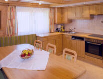 a kitchen with wooden cabinets and a dining table
