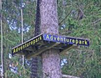 a sign in the middle of a forest