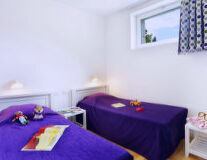 a bedroom with a purple background