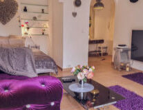 a living room with a purple flower