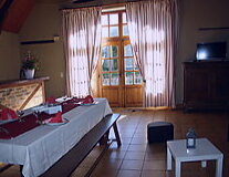a bedroom with a bed and a table in front of a window