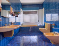 a kitchen with a blue sink and tub