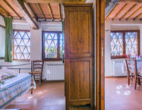 a room with a wooden floor next to a window