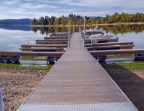 a row of wooden benches sitting next to a body of water