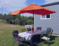 grass, outdoor, sky, tent, umbrella, table, furniture, lawn, chair, shade, canopy, outdoor table, coffee table
