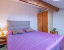 a bedroom with a purple bed