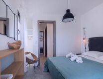 a bedroom with a bed and desk in a room