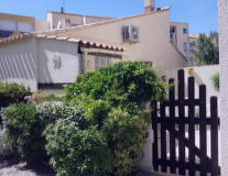 a house with a fence in front of a building