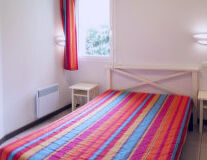 a bedroom with a colorful rug