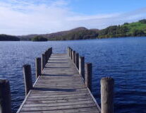 a wooden pier next to a body of water