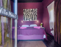 a bedroom with a purple sign