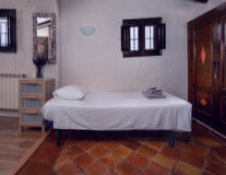 a bedroom with a tile floor