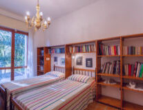 a bedroom with a bed and a book shelf