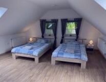 a bedroom with a wood floor