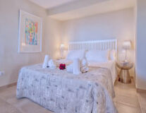 a bedroom with a bed and a mirror a bedroom with a bed and a mirror