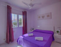 a bedroom with a purple blanket