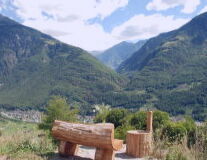 a wooden bench on the side of a mountain