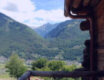 a wooden bench in front of a mountain