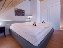 a double bed with a wooden floor