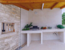 a kitchen with wooden cabinets and a fireplace