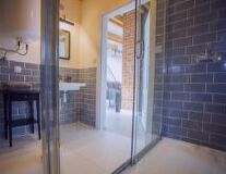 door, indoor, bathroom, floor, wall, building, window, mirror, shower, sink, plumbing fixture