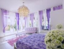 a bedroom with a purple flower