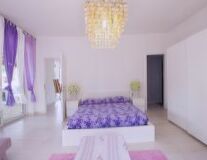 a bedroom with a purple background
