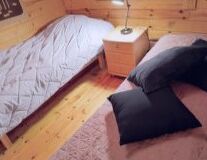 a bedroom with a bed and desk in a small room