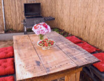 a pink flower on a wooden table