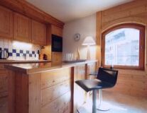 a kitchen with wooden cabinets and a window