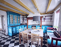 a kitchen with a blue chair in a room